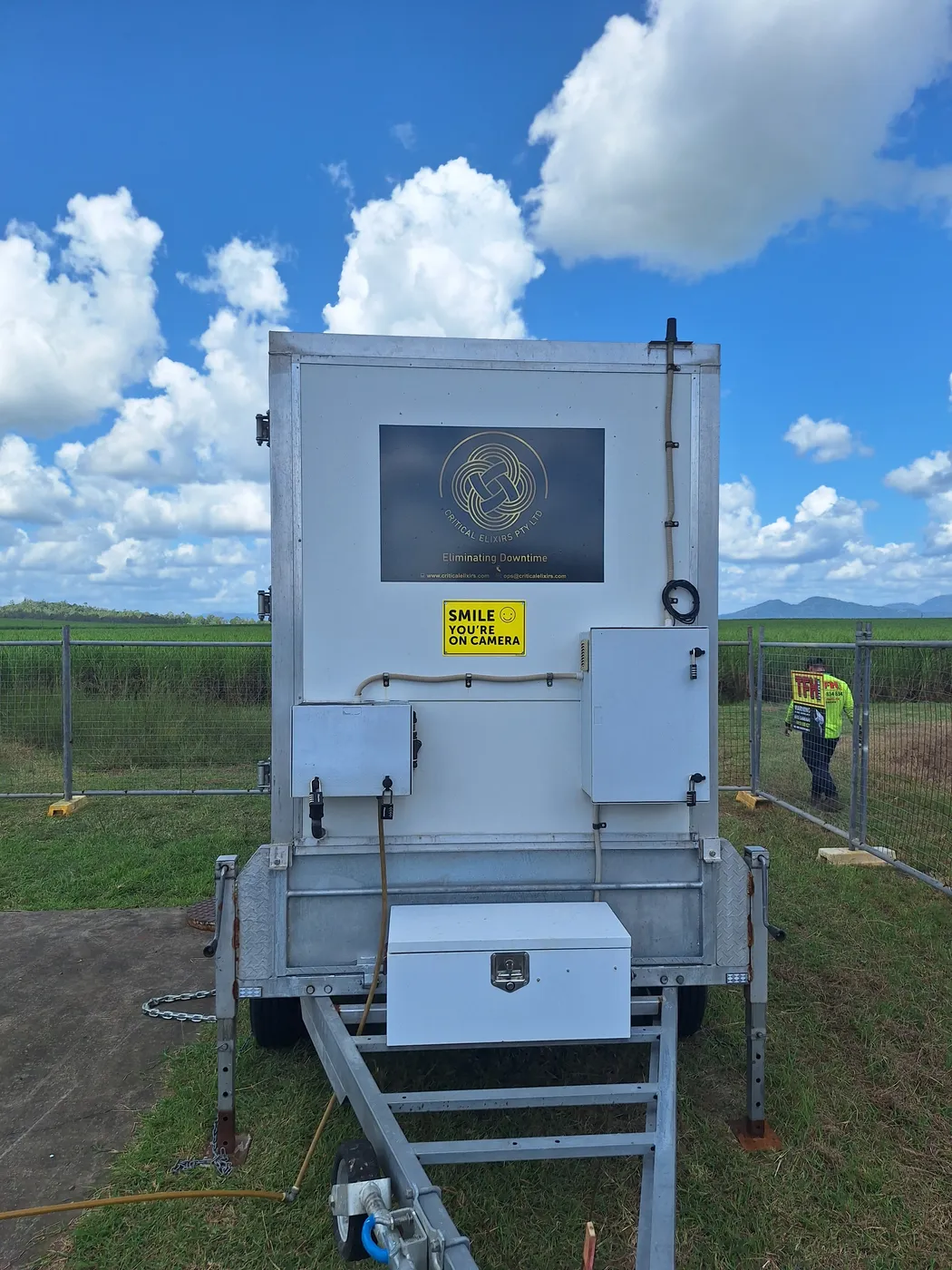 Front view of a Critical Elixirs mobile dosing trailer with its equipment enclosures and drawbar